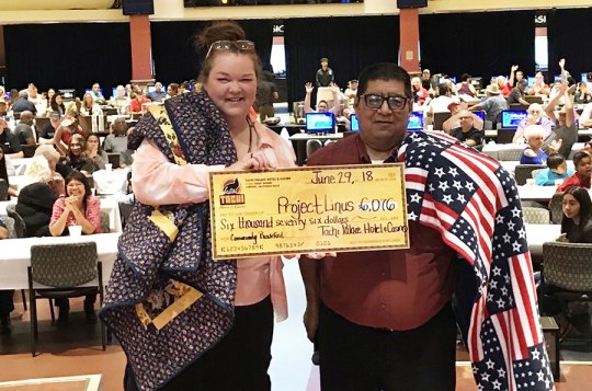 Tachi Palace General Manager Willie Barrios presents check to Project Linus Central Valley Chapter Coordinator Betsy Champ.